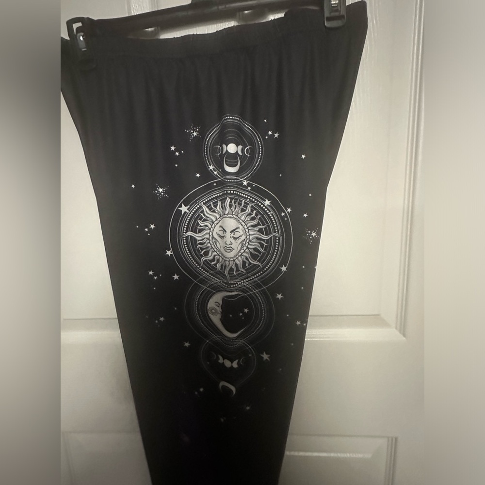 3X womens plus, pull-on black pants. With celestial print on both outer sides.